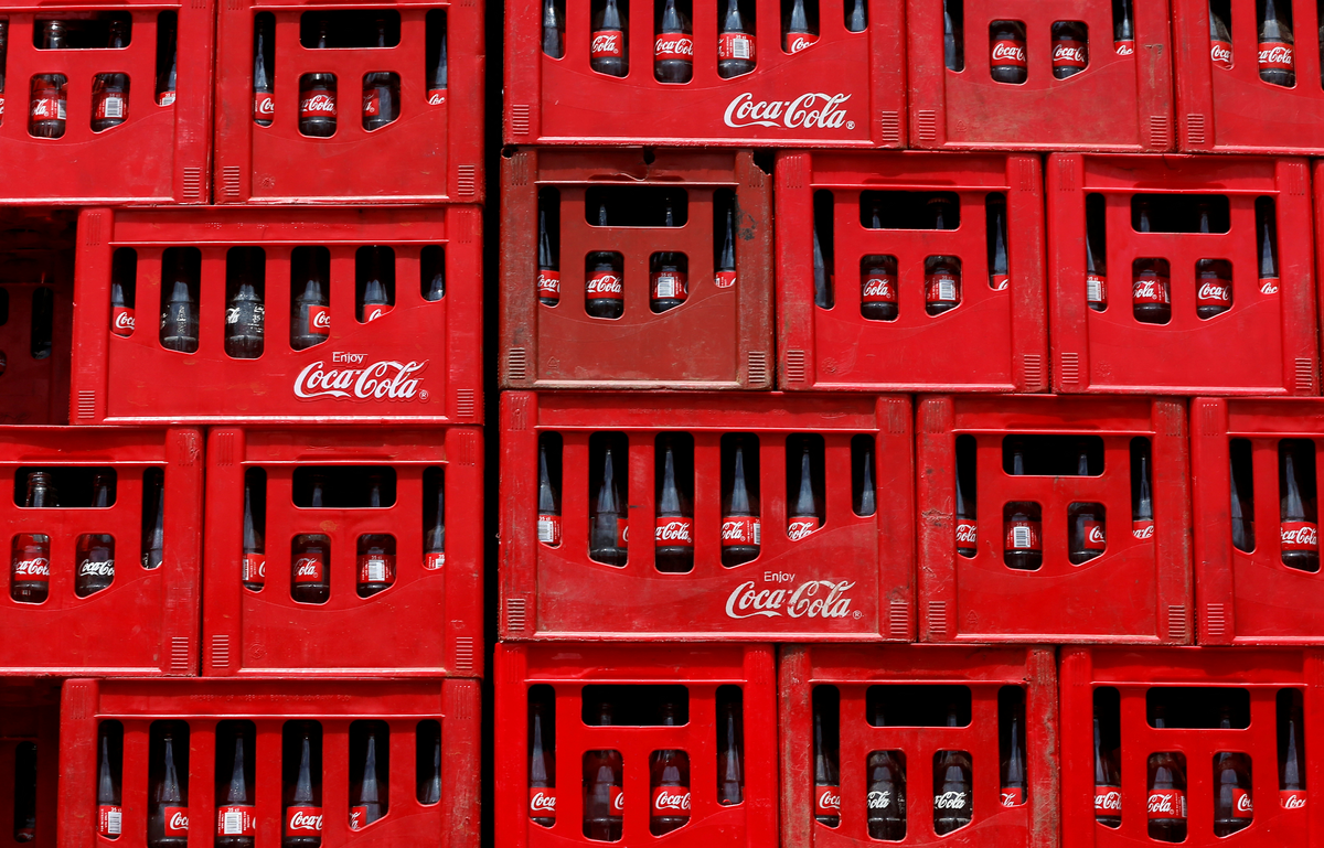 Image of Coca-Coca crates and bottles stacked on top of each other.